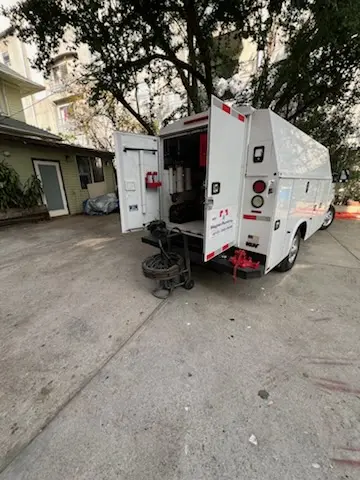 Magnet Plumbing service vehicle on-site for Grease Trap Cleaning in Shorecrest